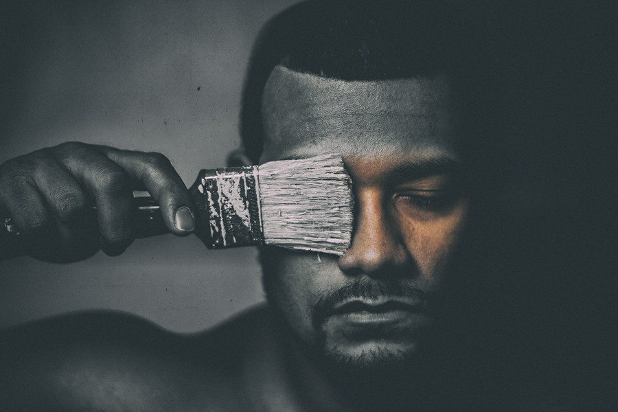 Portrait Winner July - A person in black and white, painting color back onto themselves